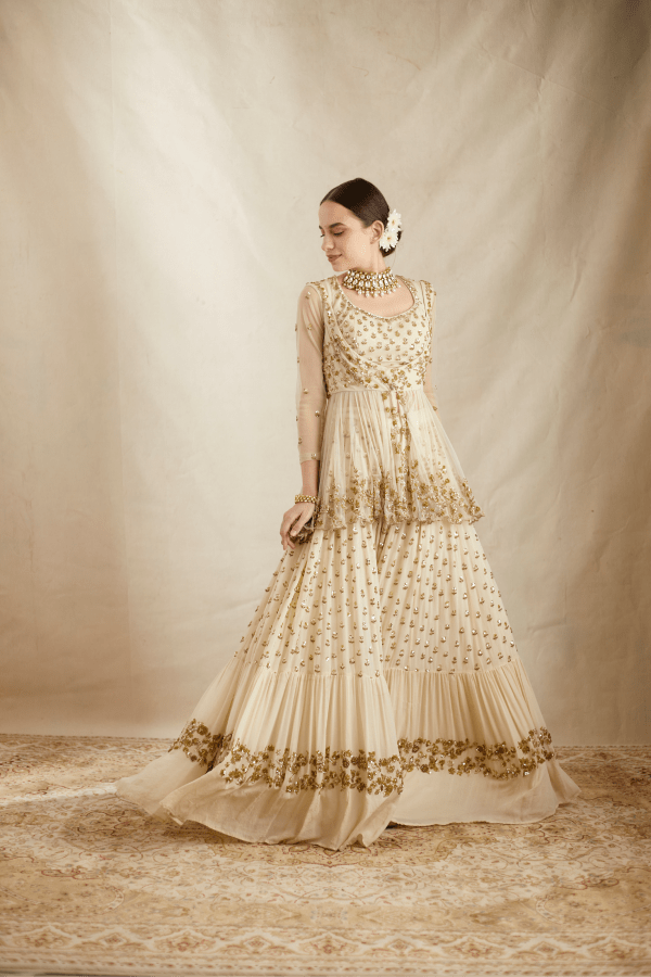 Astha Narang Off White With Gold Work Peplum And Sharara Set - The Grand Trunk Astha Narang Off White With Gold Work Peplum And Sharara Set - The Grand Trunk